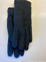 Pair of gloves stacked showing suede texture