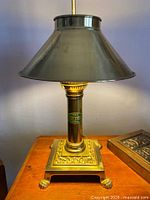 Full view of brass table lamp with metal shade
