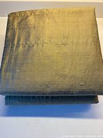 Folded silk drapery panel showing color and texture