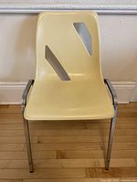 Single RODO chair front view showing cut-outs, cream seat, chrome legs