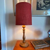 Full lamp on table showing burlap shade and wooden base