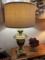 Full view of brass table lamp with shade