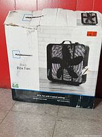 Front of damaged retail box showing fan image and specifications