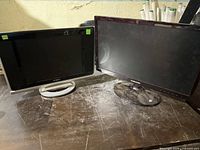 Both monitors side by side on table