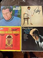 Front covers of all four vinyl records