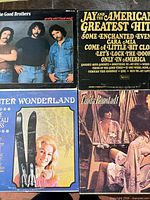 Front covers of the four vinyl albums