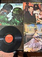 Three album jackets and one loose record visible