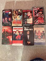 Eight VHS tapes laid out in two rows