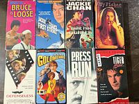 Eight VHS tapes laid out in two rows showing all front covers