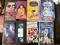 Seven VHS covers visible including Innocent Blood, Striptease, Hunchback of Notre Dame, Cinderella, Eye for an Eye, Josie and the Pussycats, Lady and the Tramp II