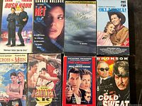 All eight VHS tapes laid out showing front covers