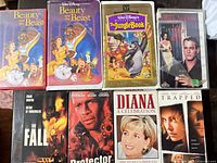 All eight VHS tapes laid out in two rows