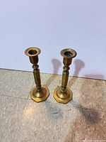 Pair of brass candlesticks front view