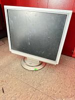 Front view of silver NEC MultiSync LCD monitor on stand