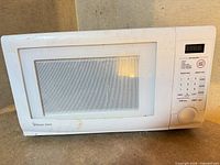 Front view showing Magic Chef logo, glass window, control panel with LED display and keypad