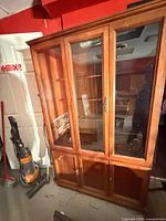 Full view of wooden china cabinet showing upper glass doors and lower wooden doors