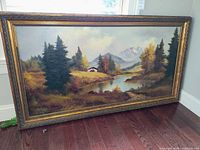 Front view of framed landscape painting showing full composition and frame detail