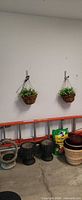 Two hanging baskets on wall, urn planters, soil bag, nested pots