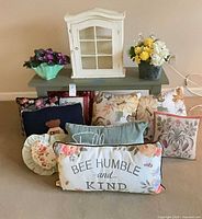Overall lot showing bench, cabinet, faux flowers and pillows