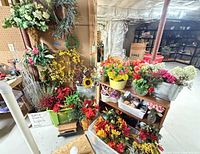 Overall view of artificial flowers in various containers