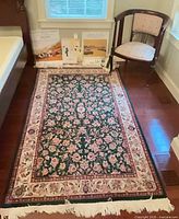 Area rug full view with fringe damage visible