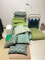 Stack of assorted cushions showing quantity and variety