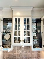 Both cabinet sections showing all china pieces and crystal jar