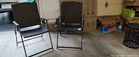 Front view of two matching folding wicker patio chairs