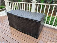 Front view of dark brown resin Suncast deck box on deck