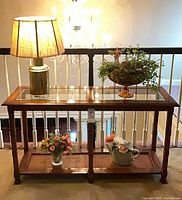 Front view of console table with lamp and florals