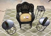 Overhead view of wicker rocker, two round metal tables, square metal stand, and stained glass votives