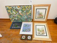 Front view of all seven framed floral artworks