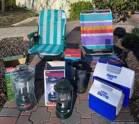 Full lot overview showing chairs, lanterns, coolers, thermos