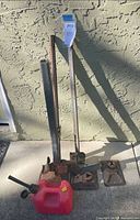 Full view of bumper jack, base plates, red gas can