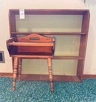 End table in front of bookcase showing both items together
