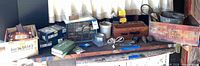 Overview of bench with organizer cabinet, floodlight boxes, Snap-Seal box, wooden crate, bucket, small tools