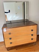 Front view of dresser with mirror showing three drawers and metal pulls
