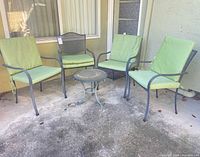 Full set showing 4 chairs and round table on patio