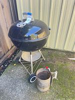 Weber kettle charcoal grill on stand with chimney starter