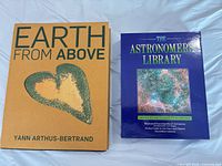 Front covers of both books: Earth From Above and The Astronomer's Library