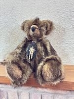 Full view of seated brown mohair teddy bear on ledge