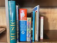 Books on shelf showing titles and formats