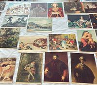 Spread of assorted colour art prints laid out on table