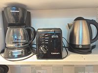 All three appliances on shelf: coffee maker, toaster, kettle