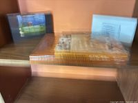 Three items stacked: two books, one video case