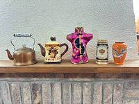 Group shot of all five collectibles on mantel