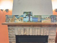 All six paintings displayed on mantel for group view