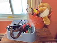 Overall lot with bowl containing leashes/collars and bucket with plush toys