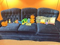 overview of all toys laid out on blue couch