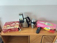 Overall lot showing five small appliances and accessory boxes